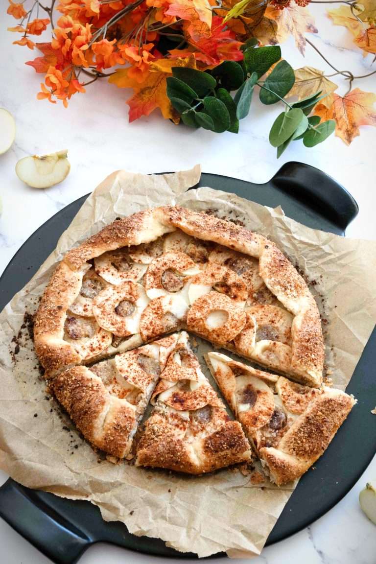 An apple galette with a couple of slices cut ready to be served.
