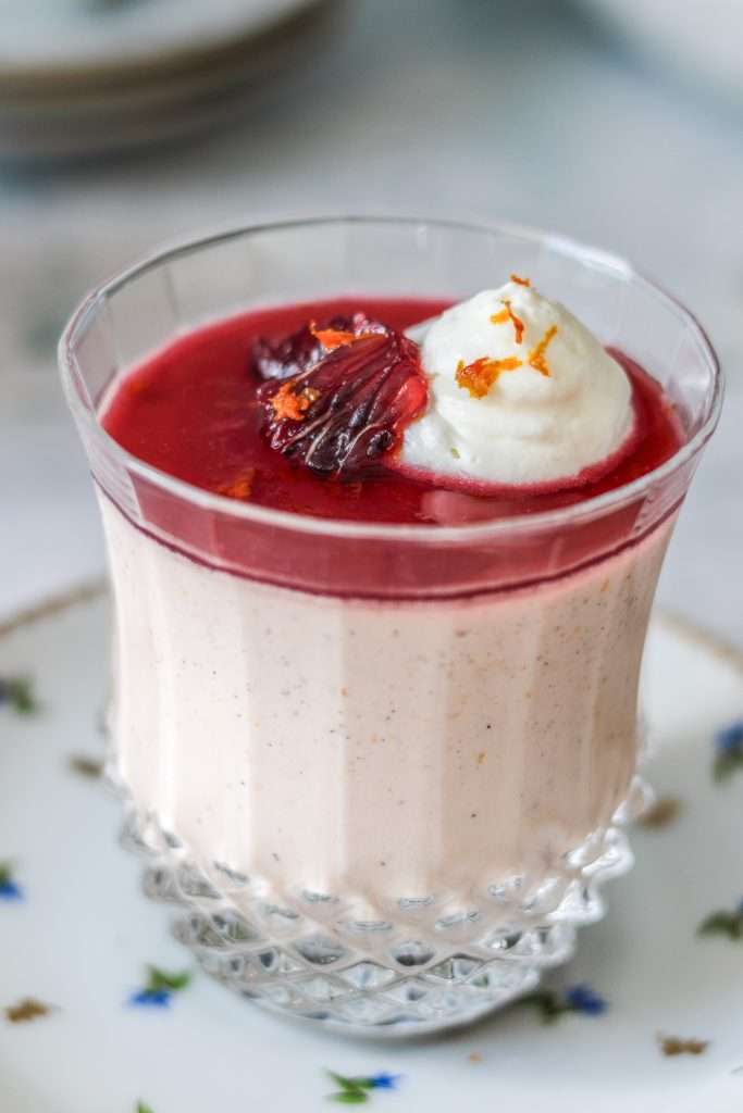 Blood orange panna cotta served in a glass.
