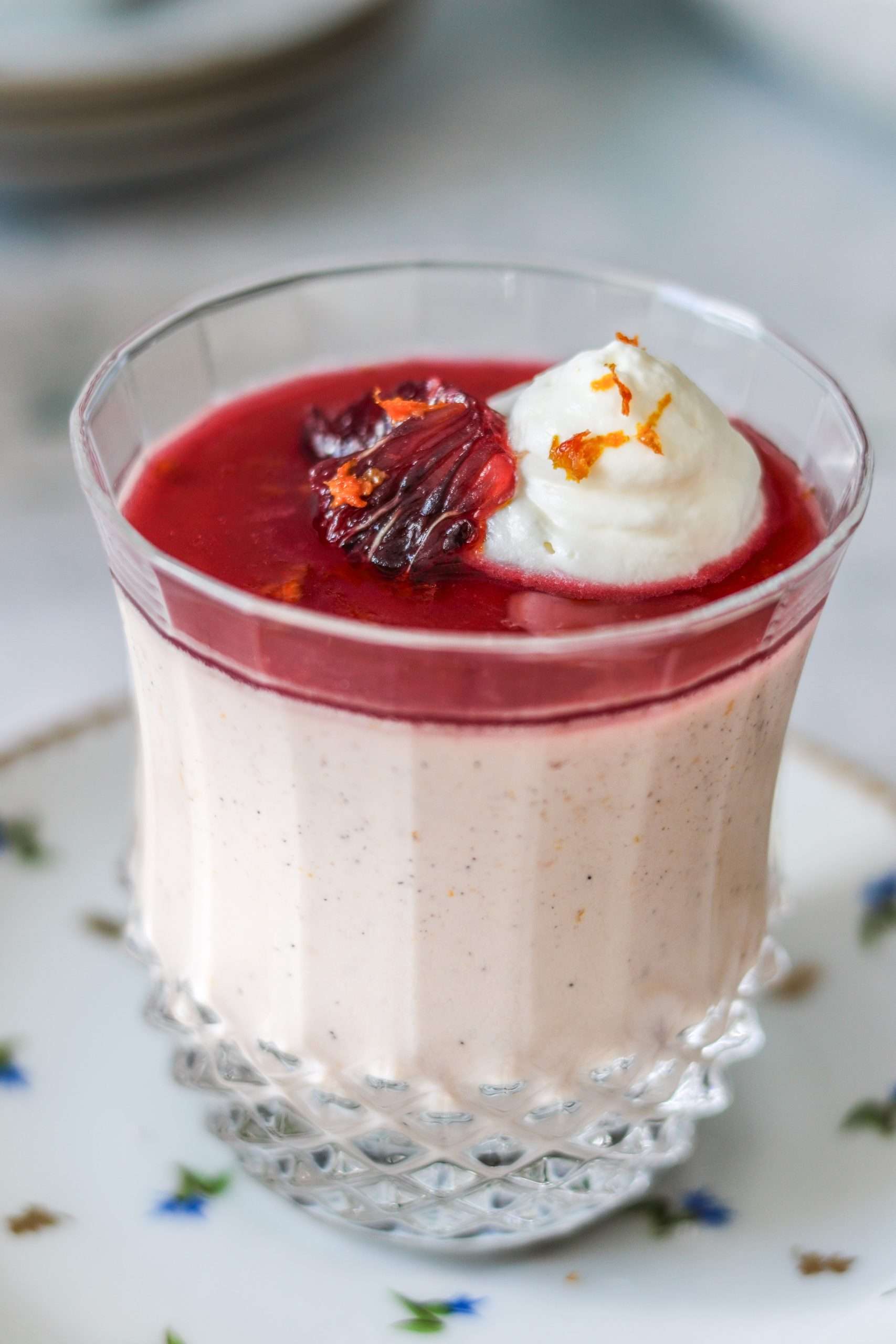 Blood orange panna cotta served in a glass.