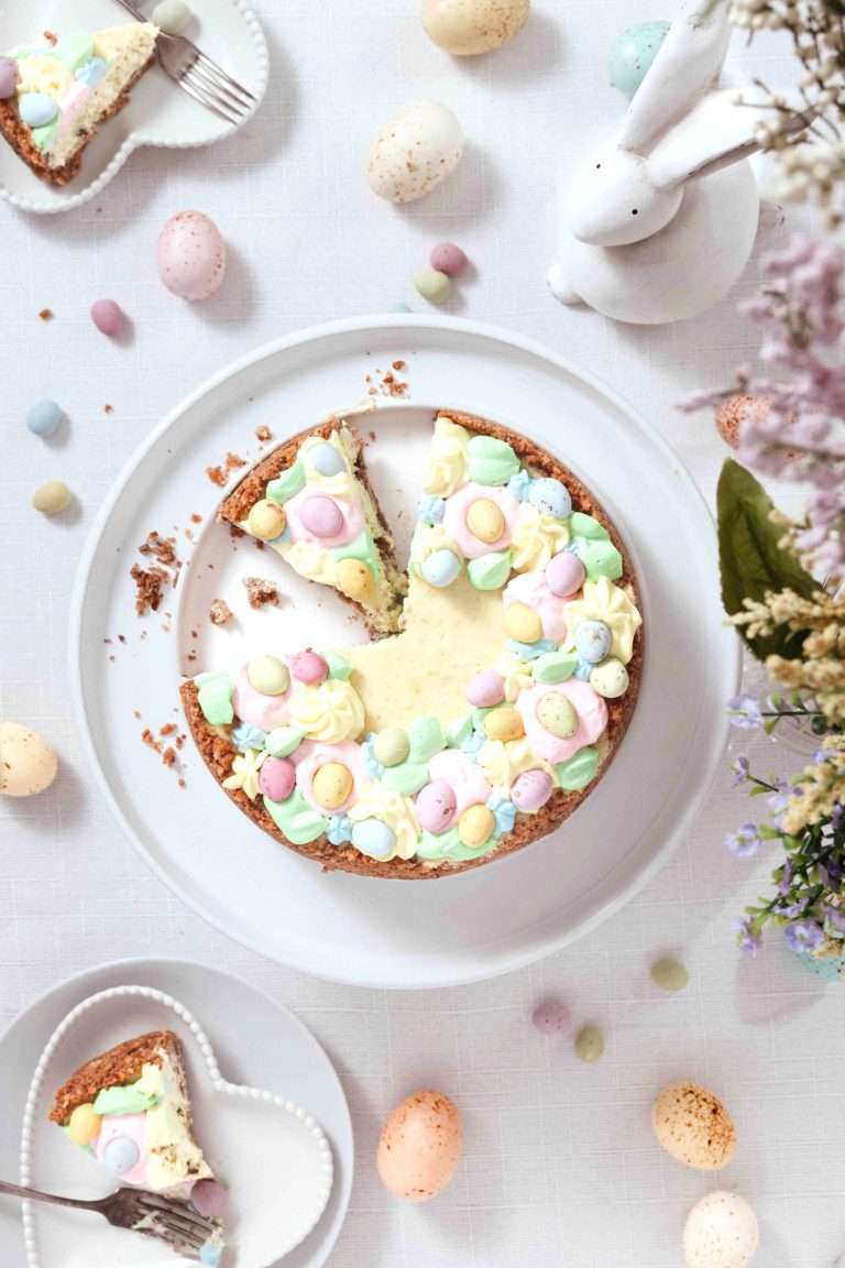 Easter cheese cake seen from the top with pastel colored chocolate mini eggs.