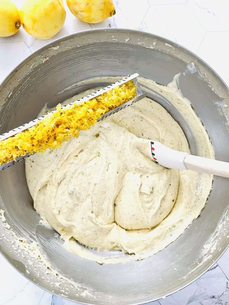 Lemon Pistachio Cake with Cream Cheese Frosting 15 Creaming together the butter, sugar and eggs and adding the lemon zest to the batter.