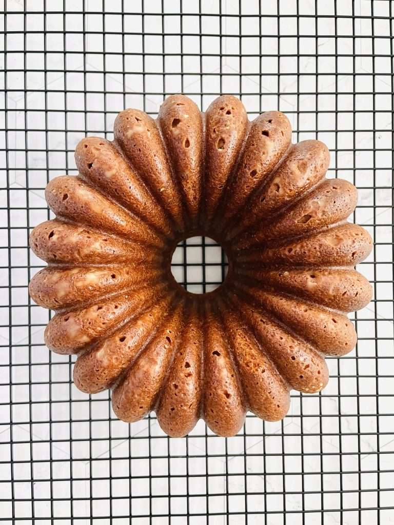 Lemon Pistachio Cake with Cream Cheese Frosting 19 Freshly baked lemon pistachio cake on a wire cooling rack.