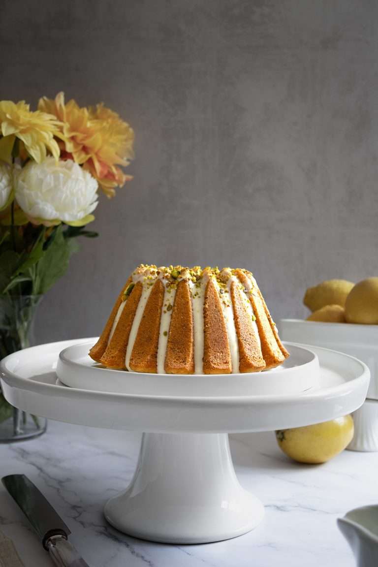 Lemon Pistachio Bundt Cake on a cake stand.