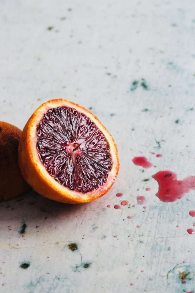 Juicy blood orange cut in half.