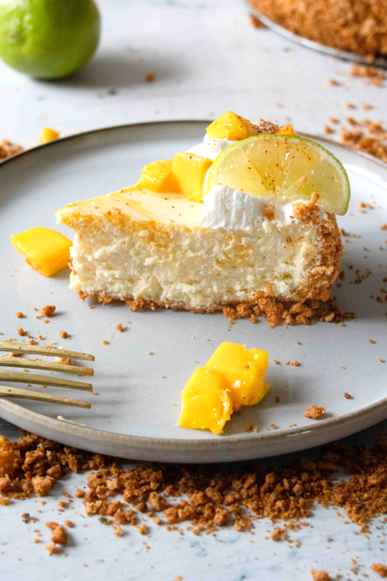 Mango lime cheesecake slice seen from the side.