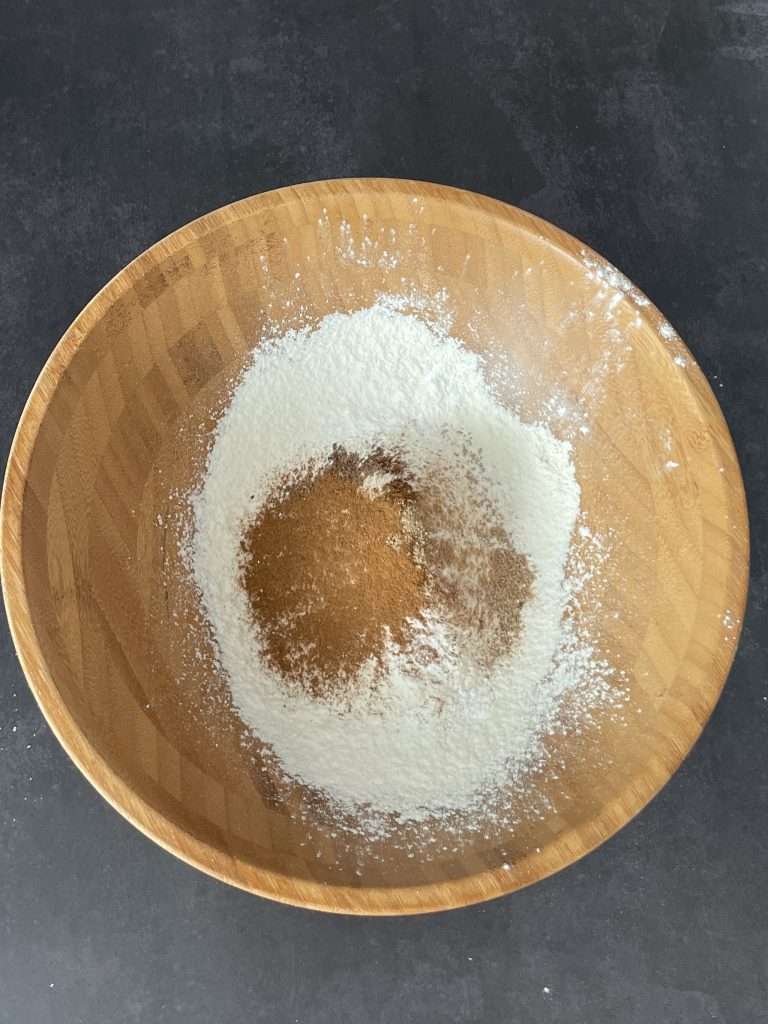 Basler Läckerli (Traditional Swiss Honey Spice Cookies) 13 Flour and spices for Swiss Basler lakerli cookies in a large wooden bowl.