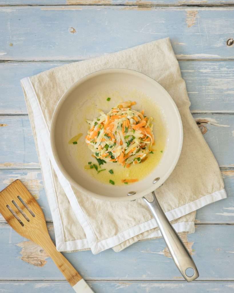 Spring Carrot Rösti Recipe with Lemon and Herbs 23 Carrot and potato rosti patty in a pan ready to be fried.