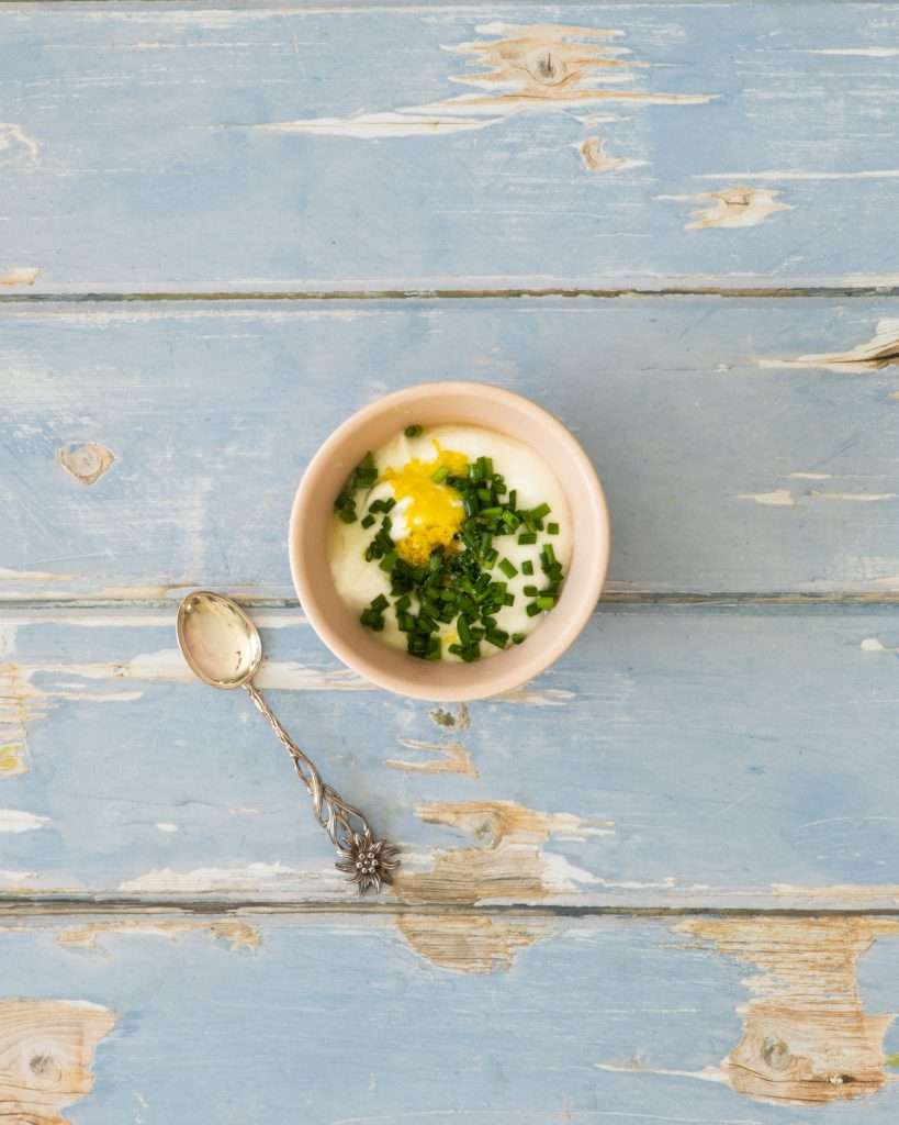 Spring Carrot Rösti Recipe with Lemon and Herbs 31 Herby lemon yogurt in a small bowl.