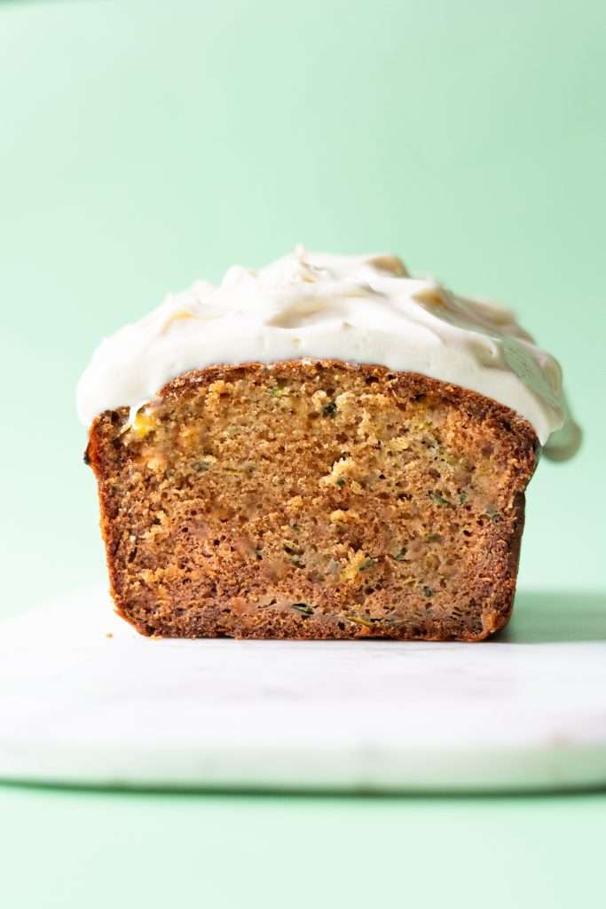Zucchini bread loaf seen from face on to show the moist crumb texture.