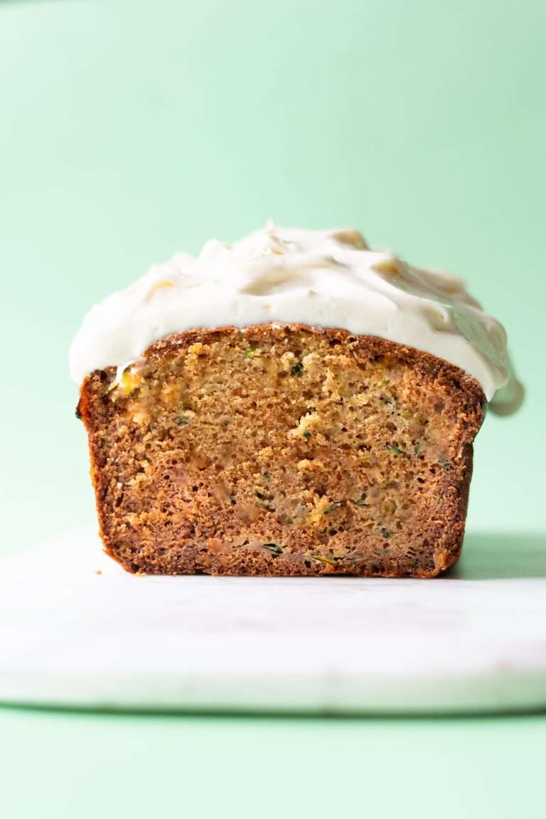 Zucchini bread loaf seen from face on to show the moist crumb texture.