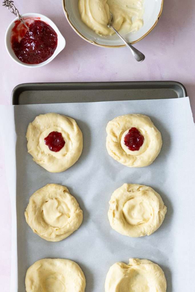 Strawberry Rhubarb Brioche Buns with Baked Vanilla Cream 29 Adding a bit of vanilla cream and strawberry rhubarb jam to the center of each of the brioche buns before baking.