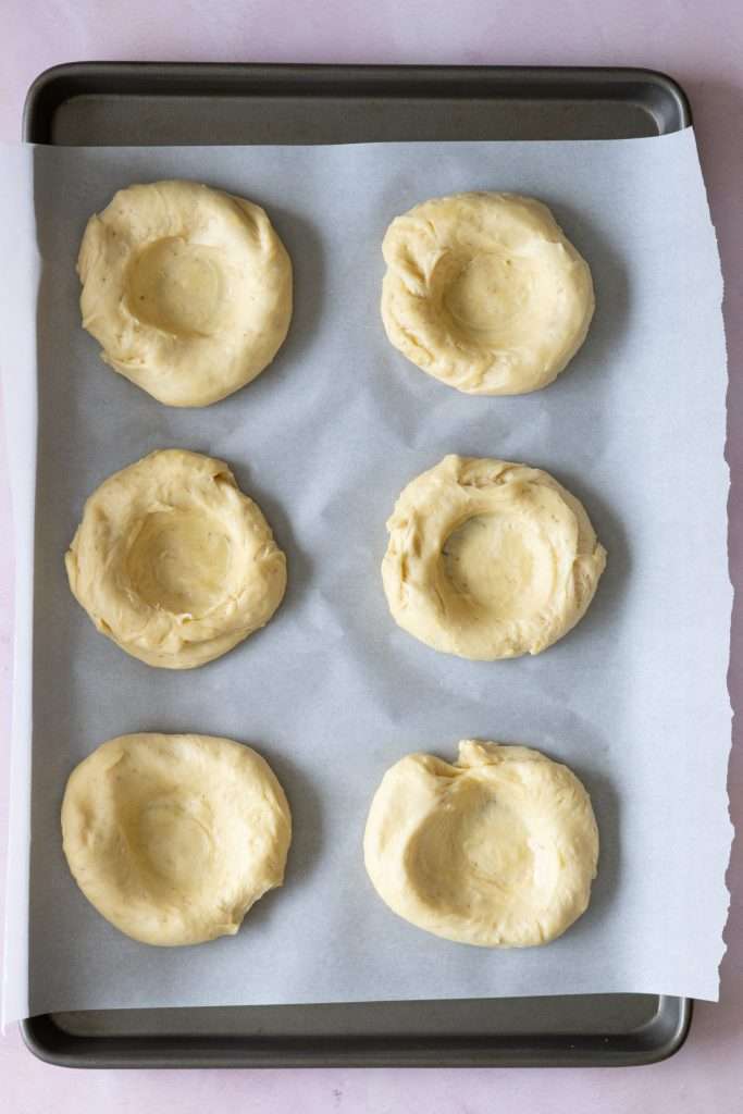 Strawberry Rhubarb Brioche Buns with Baked Vanilla Cream 27 Shaping the brioche buns by adding a well to the center of each dough ball.