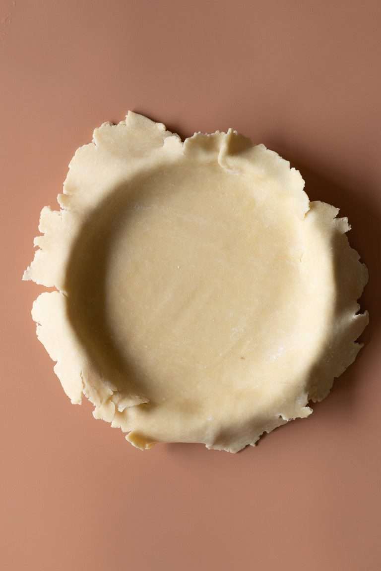 A butter pie dough in a baking dish ready to be filled.