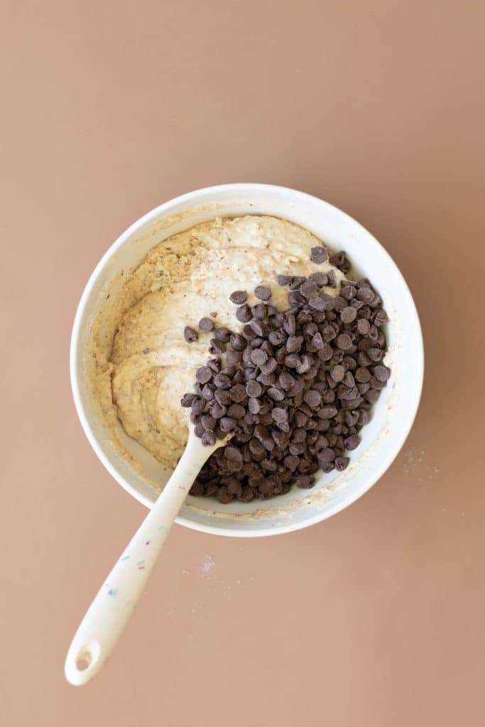 Adding the chocolate chips to the cake batter.