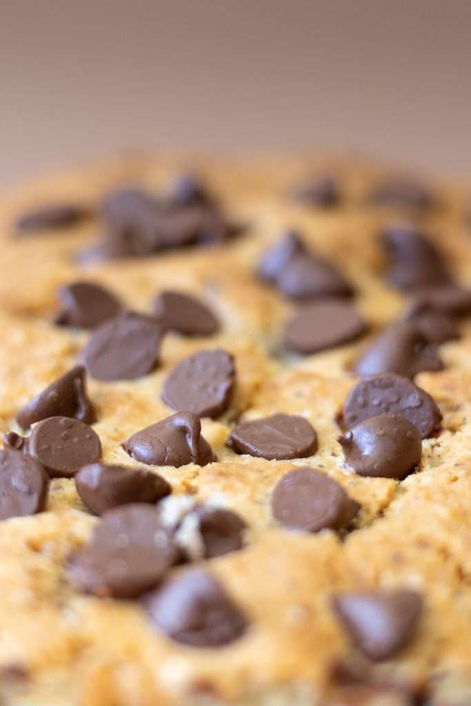 Close-up of the top of the chocolate hazelnut cake showing the crisp top of the loaf and the chocolate chips.