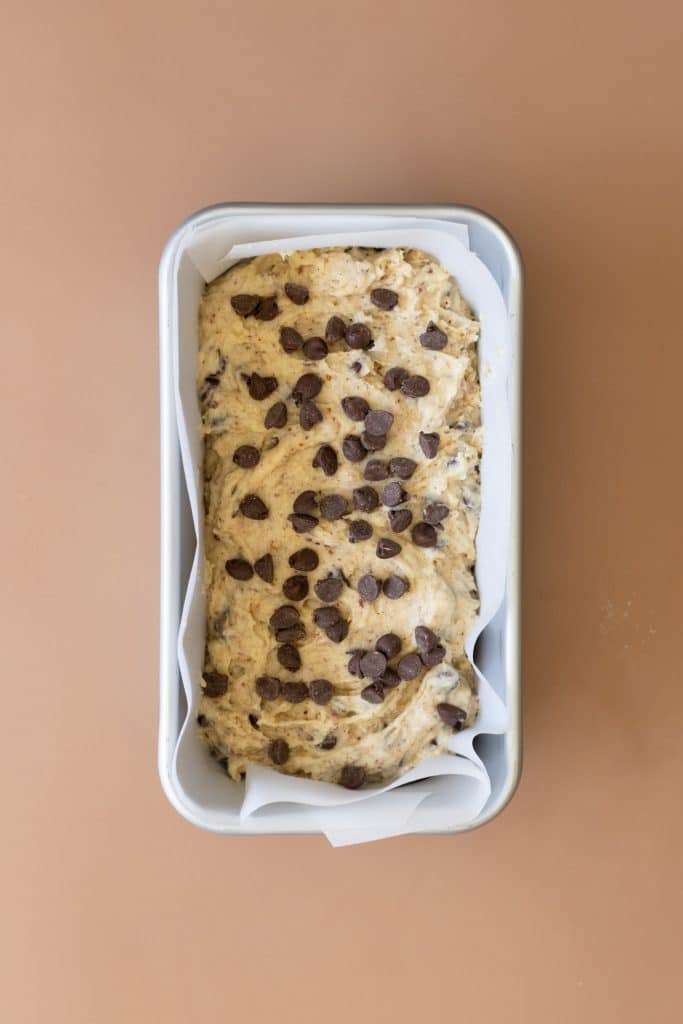 Chocolate hazelnut cake batter in a loaf pan pre-bake.