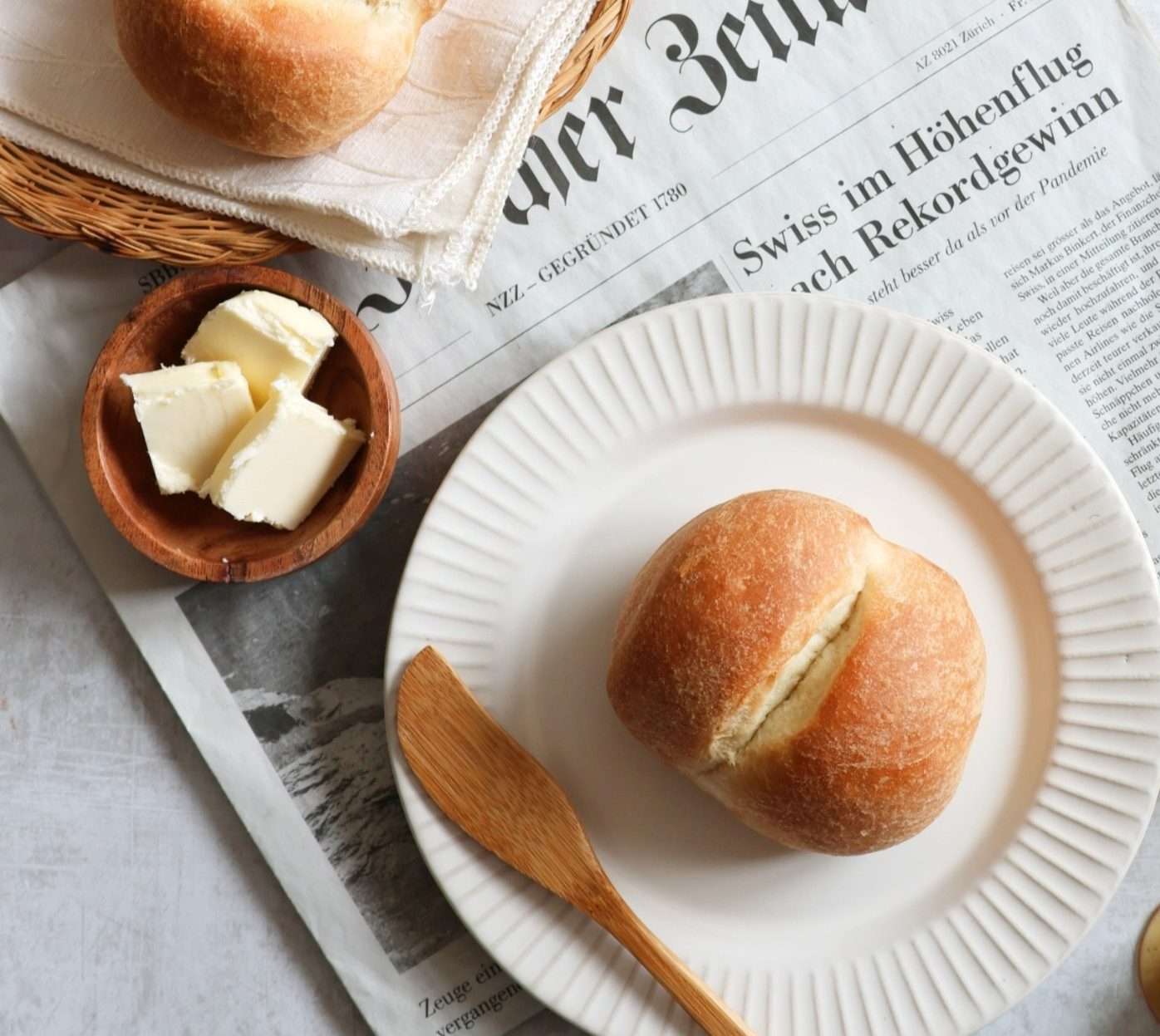 12 Easy Swiss Recipes You Can Try at Home 19 A Swiss bread roll called weggli on a plate.