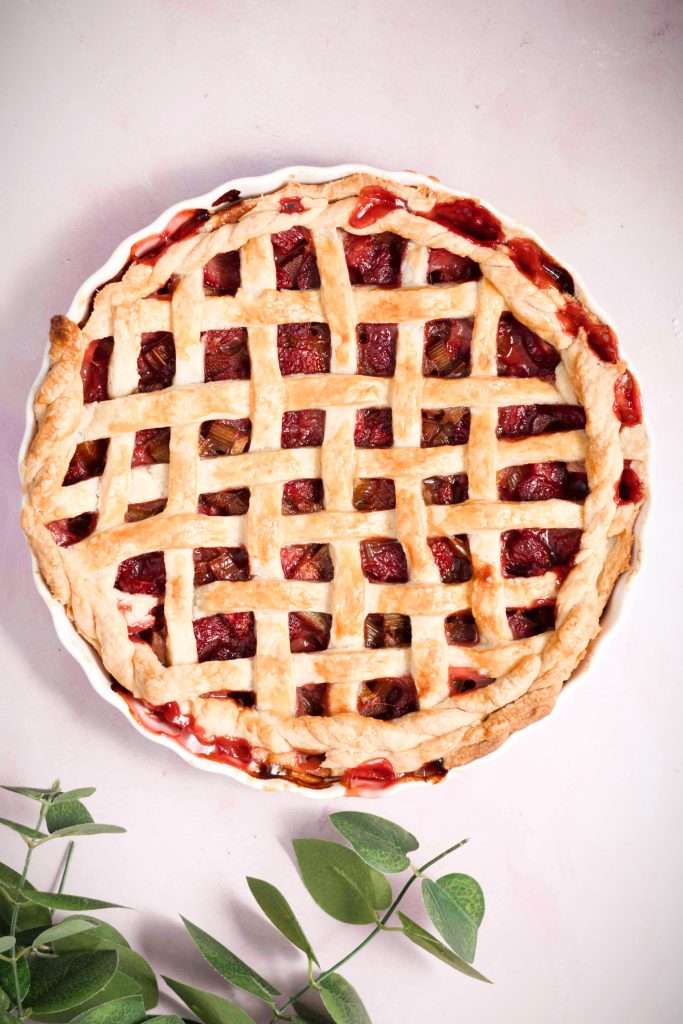 Freshly baked strawberry rhubarb tart with a lattice top.