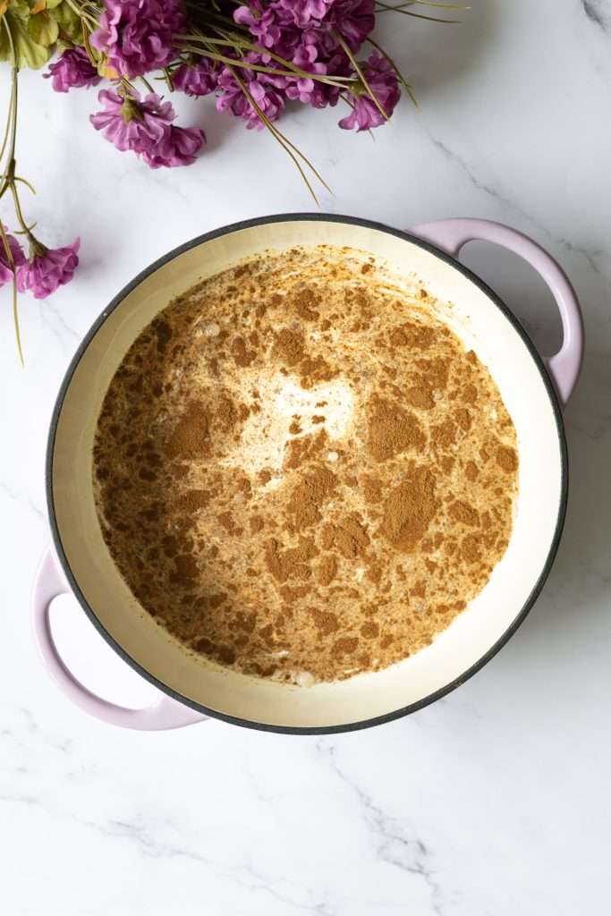 Homemade Coffee Ice Cream with Chocolate & Meringue 11 Instant espresso powder added to a cream and milk mixture in a shallow cooking pot.