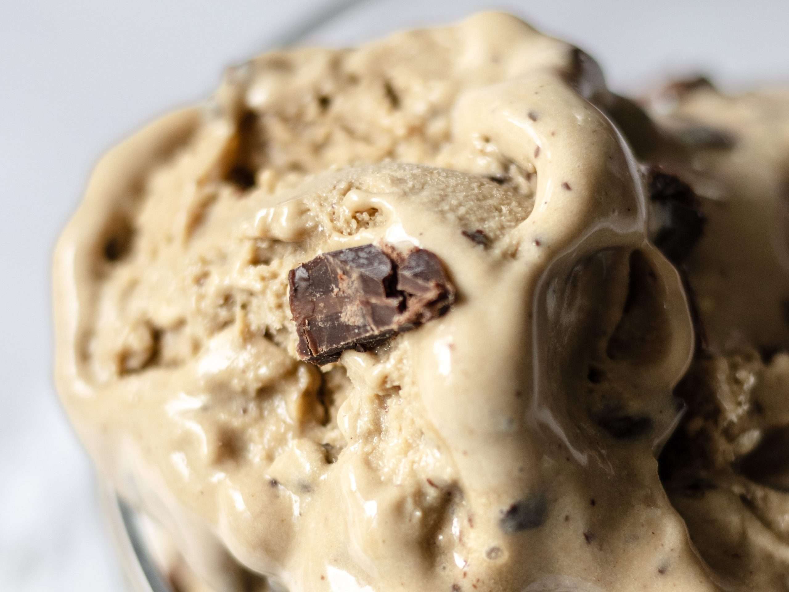 Homemade Coffee Ice Cream with Chocolate & Meringue 5 Coffee ice cream in a glass where the creamy texture and chocolate bits are seen.