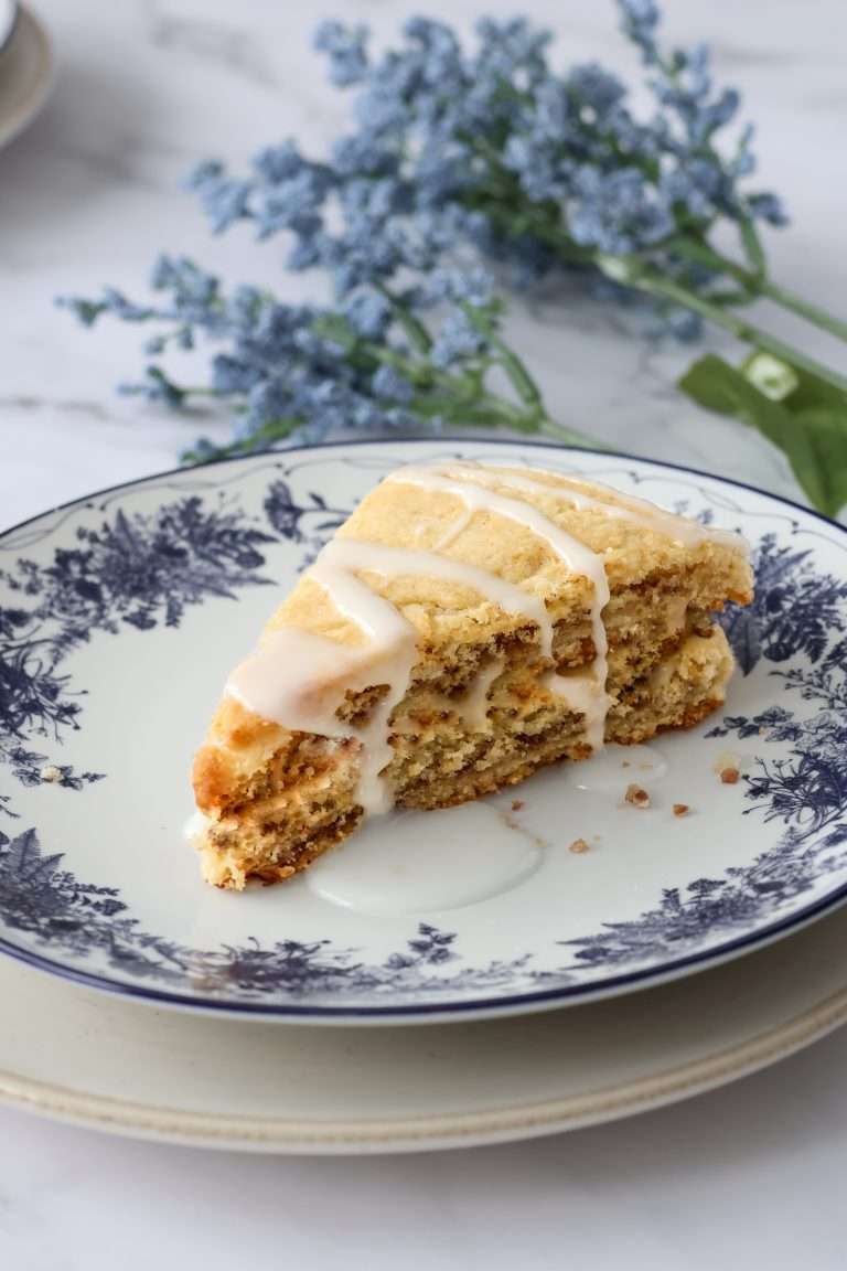 Cinnamon layered scone on a floral designed plate.