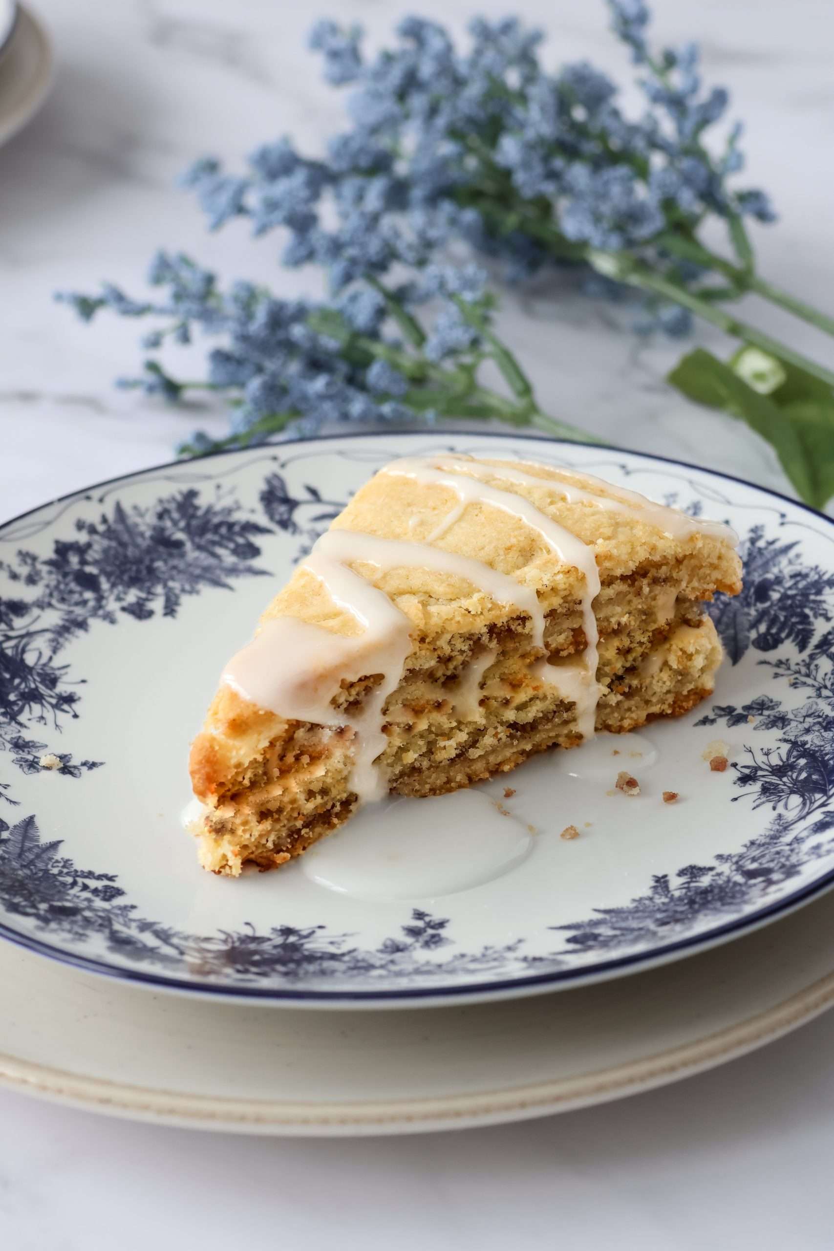 Cinnamon layered scone on a floral designed plate.