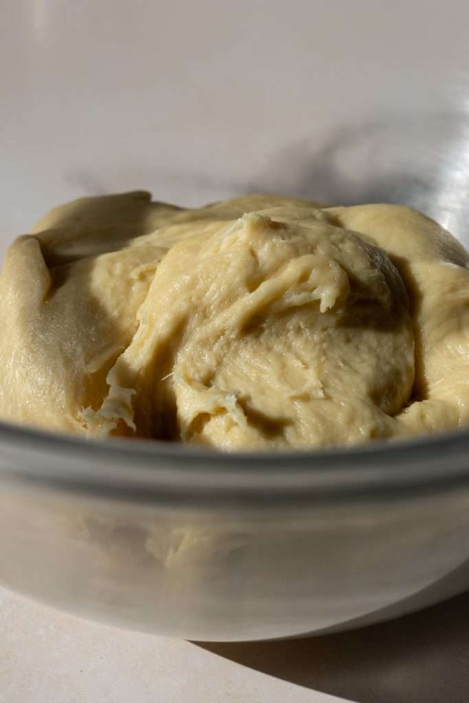 Maple Brioche with a Maple Sugar Swirl 13 Maple brioche dough close-up in a glass mixing bowl.
