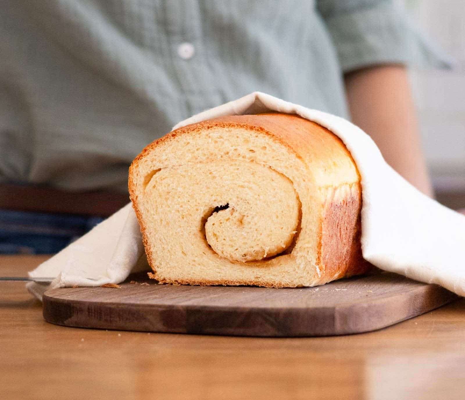 Maple Brioche with a Maple Sugar Swirl 23 A loaf of maple brioche on a cutting board having been sliced to show the maple swirl.