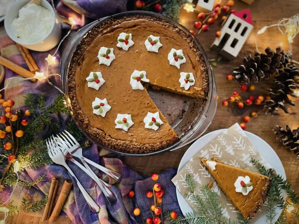 Classic Pumpkin Pie with Graham Cracker Crust 13 Finished pumpkin pie decorated with whippes cream dollops.
